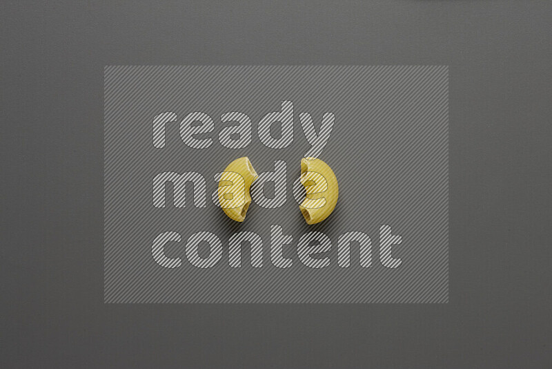 Elbow pasta on grey background