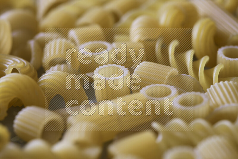 Different pasta types on light blue background