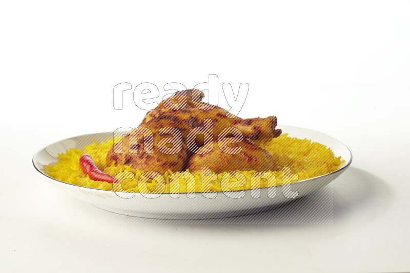 yellow  basmati Rice with kabsa chicken pieces on a white plate with a silver rim direct on white background