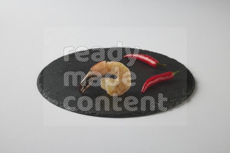 one  grilled shrimp  on a black slate direct  on a white back ground