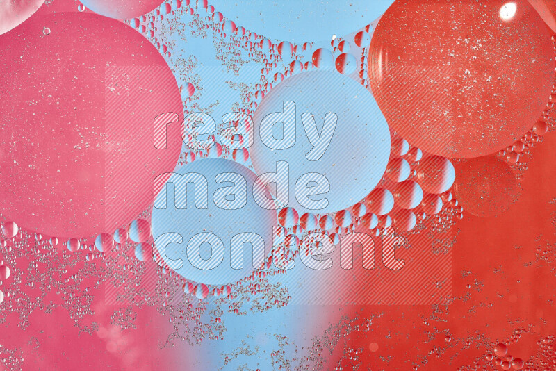 Close-ups of abstract oil bubbles on water surface in shades of blue, red and pink