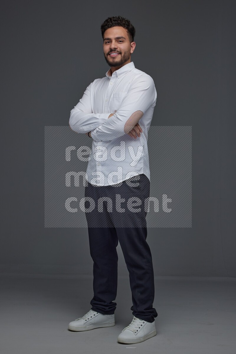 A man wearing smart casual making multi stand poses  eye level on a gray background