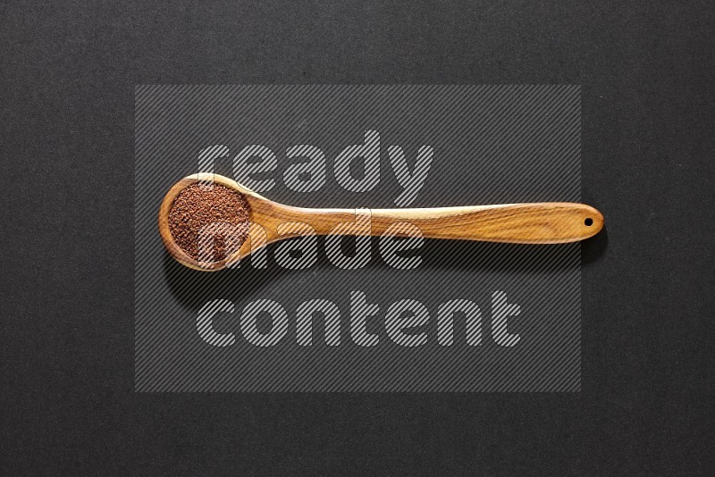 A wooden ladle full of garden cress on a black flooring in different angles