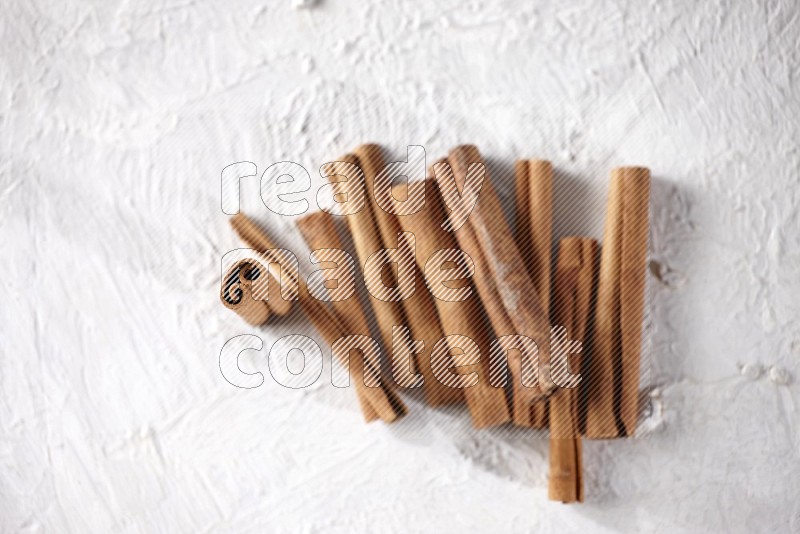 Cinnamon sticks on a textured white background