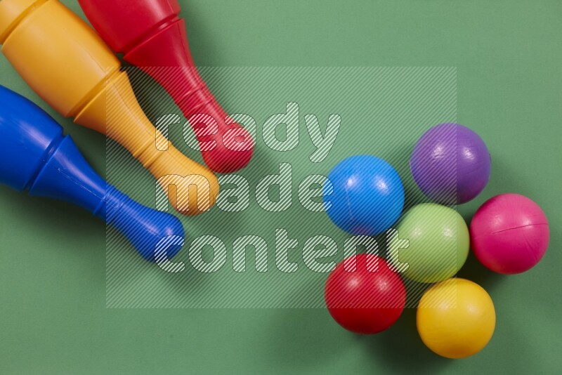 Plastic bowling pins with balls on different colored backgrounds (kids toys)