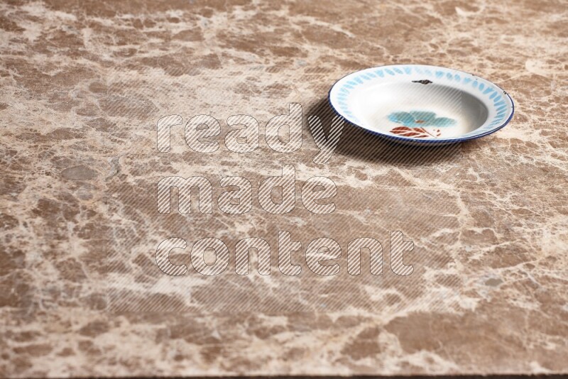 A vintage metal plate on beige marble background