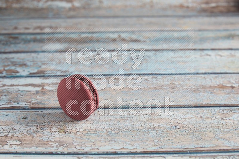 45º Shot of Red Cherry macaron on light blue wooden background