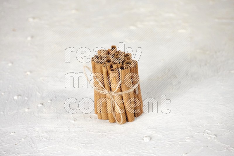 A bounded stack of cinnamon sticks on white background