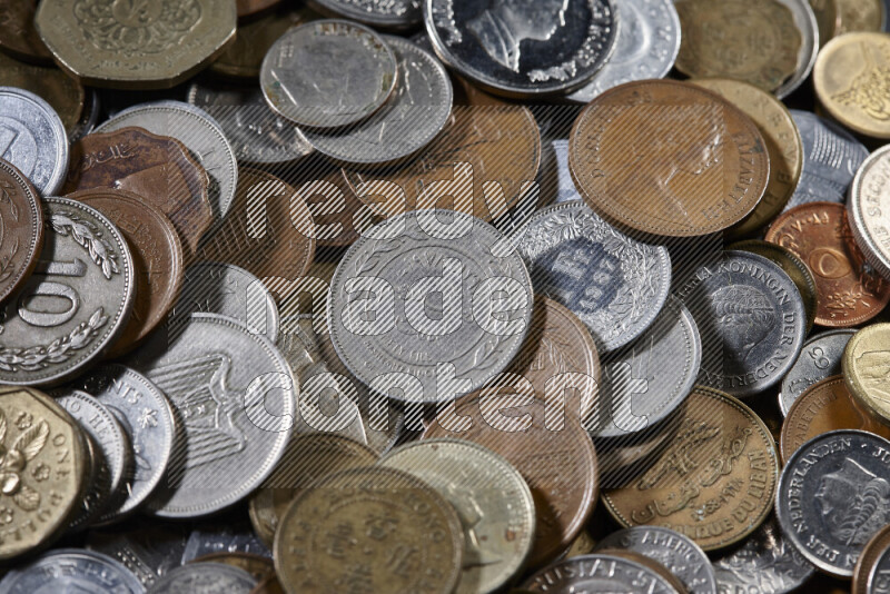 A close-ups of random old coins on black background