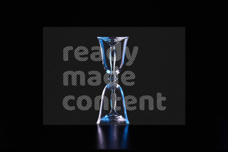 Glassware with rim light in blue and white against black background