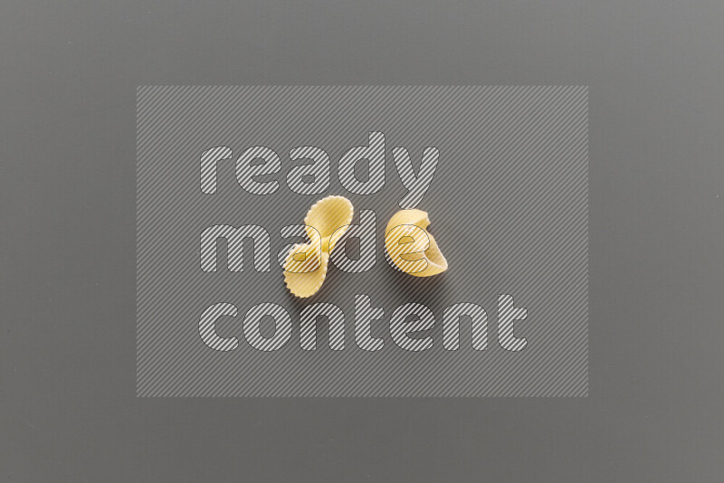 Fiocchi pasta with other types of pasta on grey background