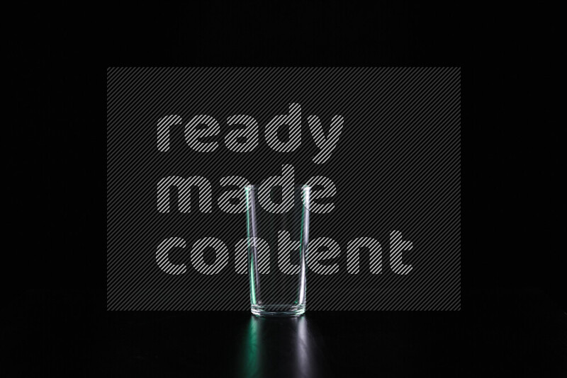 Glassware with rim light in green and white against black background