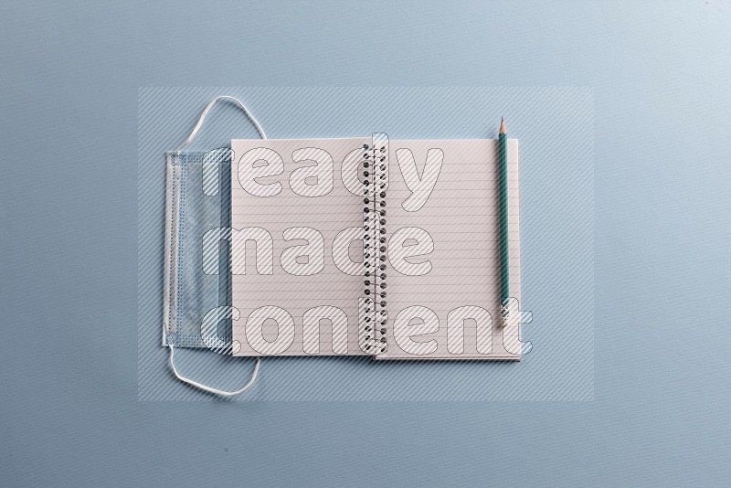 A blank open notebook with school supplies on blue background (Back to school)