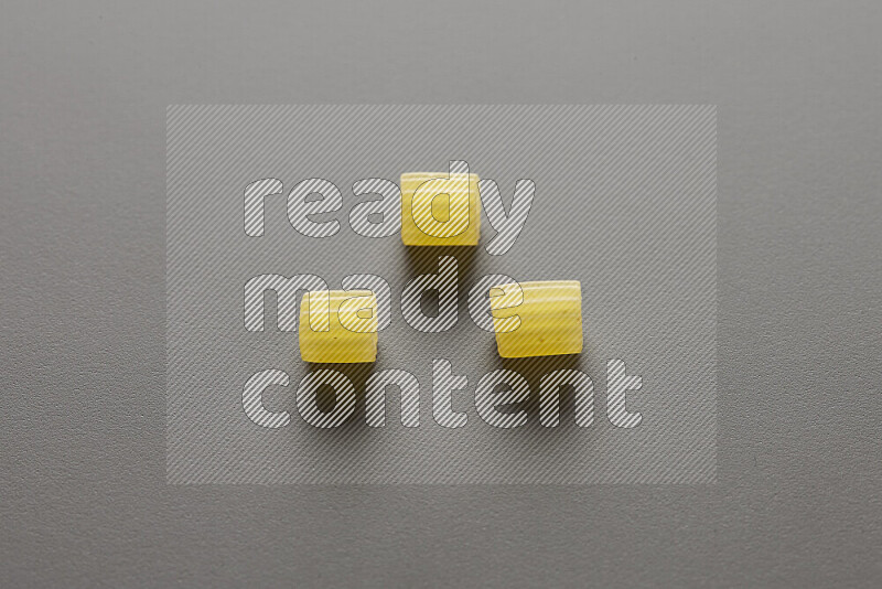 Small rings pasta on grey background