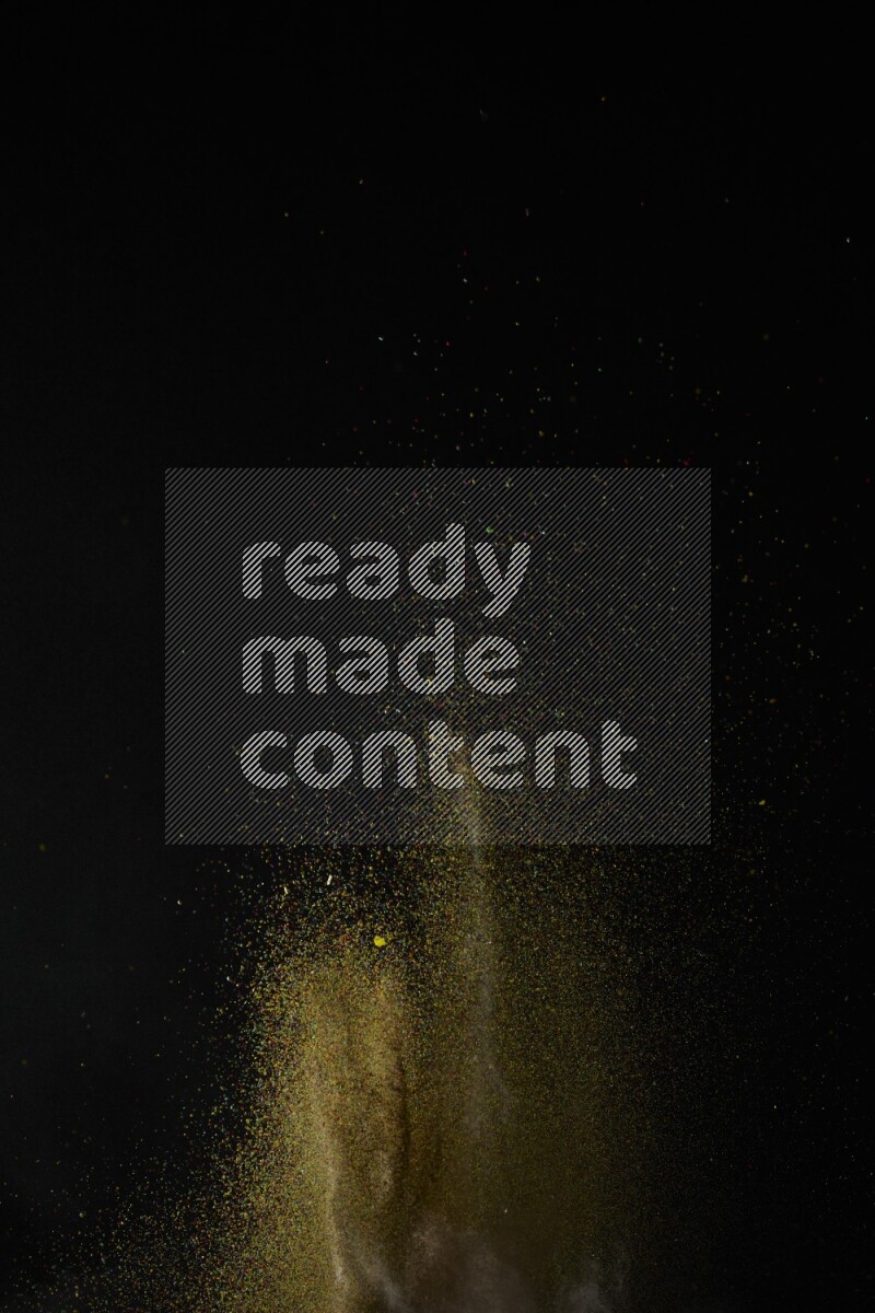 A side view of brown powder explosion on black background