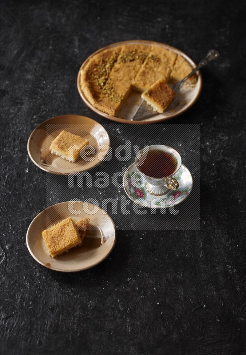 konafa with tea in a dark setup