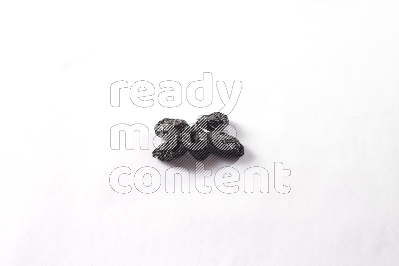 Dried plums on white background