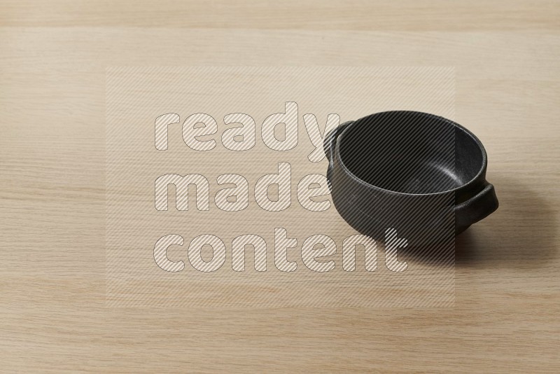 Black Pottery Bowl on Oak Wooden Flooring, 45 degrees