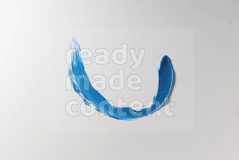 A blue single curved painting knife stroke on a white background