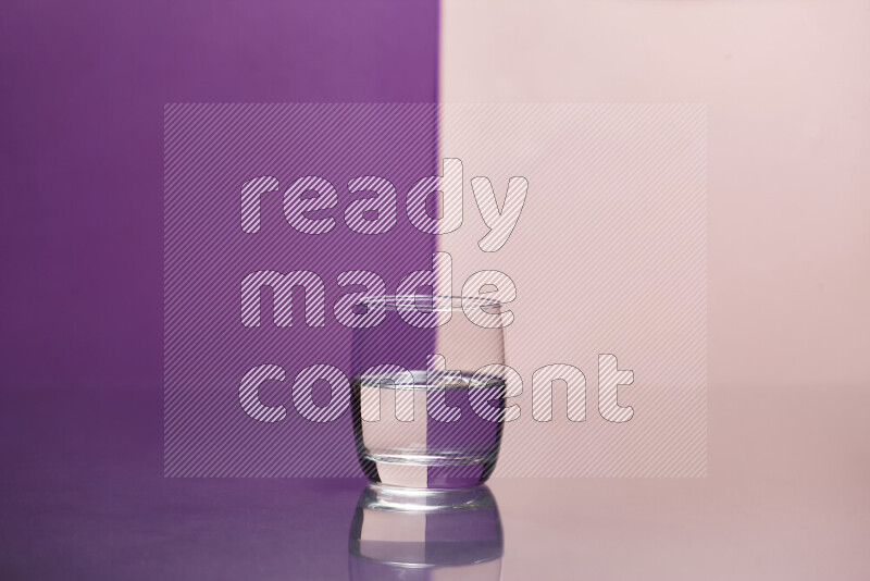 The image features a clear glassware filled with water, set against purple and rose background