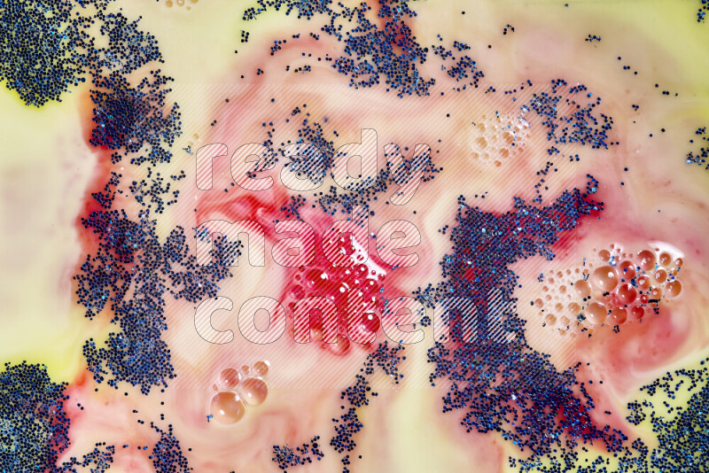 لقطة مقربة لبريق أزرق متلألئ منتشر على خلفية من اللون الأصفر والأحمر في حركات دائرية