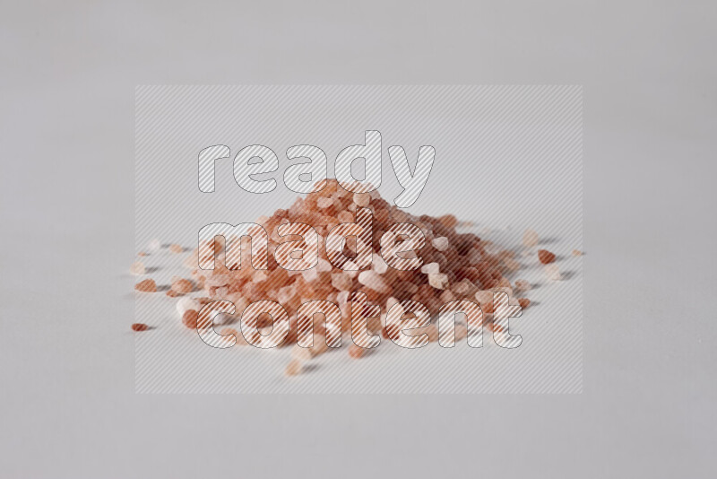 A bunch of coarse himalayan salt crystals on white background