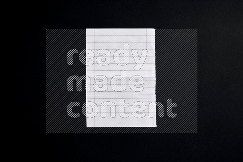 Folded notebook sheet on black background
