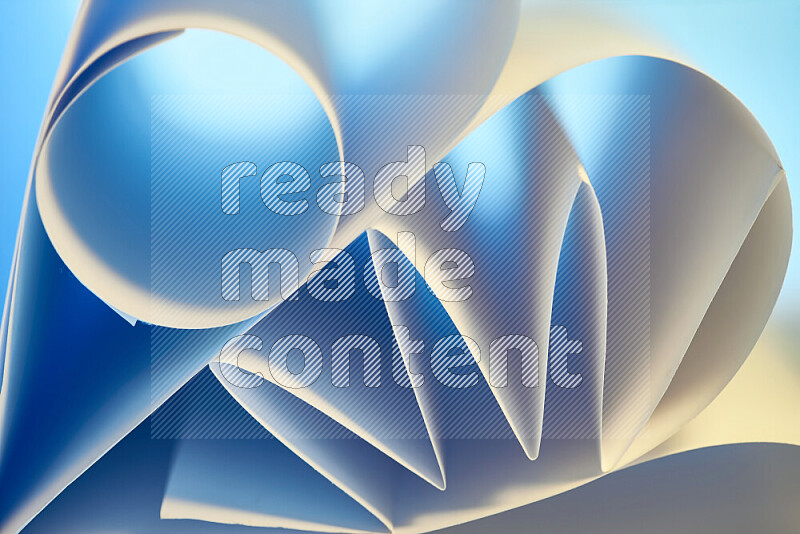 عرض فني لطيات الورق تخلق مزيج من الأشكال الهندسية، مضاءة بإضاءة ناعمة بدرجات اللون الأزرق والالوان الدافئة