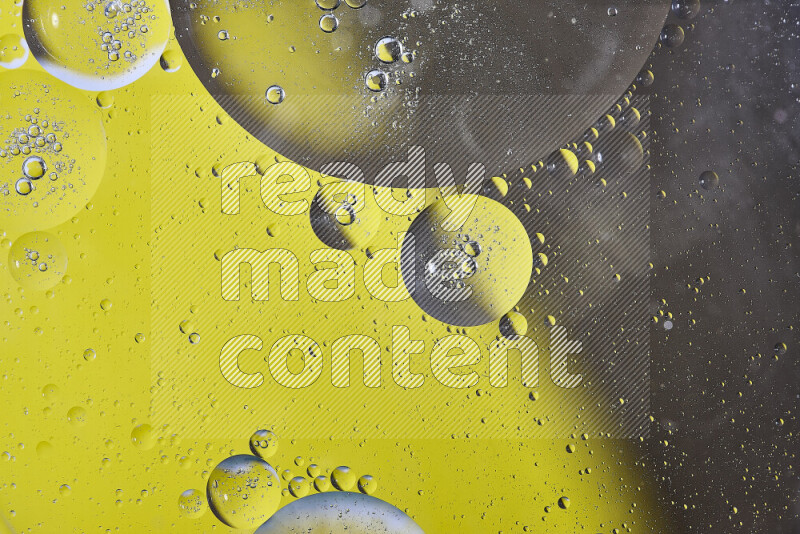 Close-ups of abstract oil bubbles on water surface in shades of yellow and brown