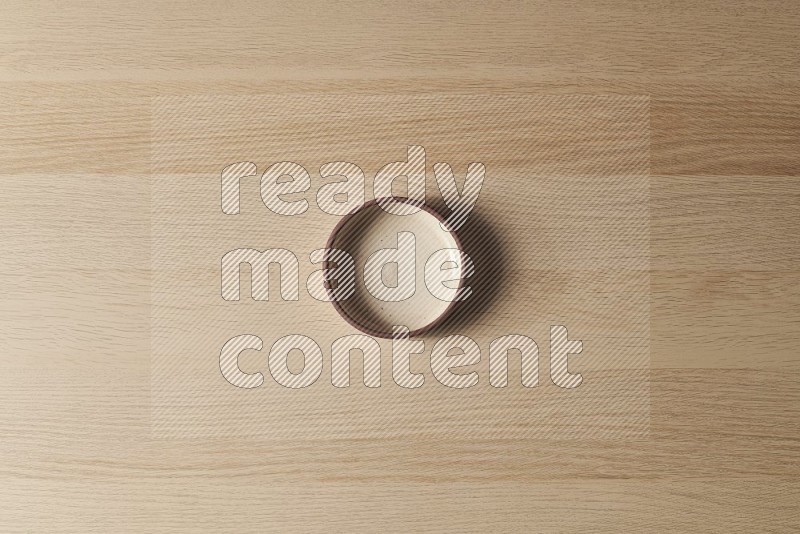 Top View Shot Of A Beige Pottery Oven Plate on Oak Wooden Flooring