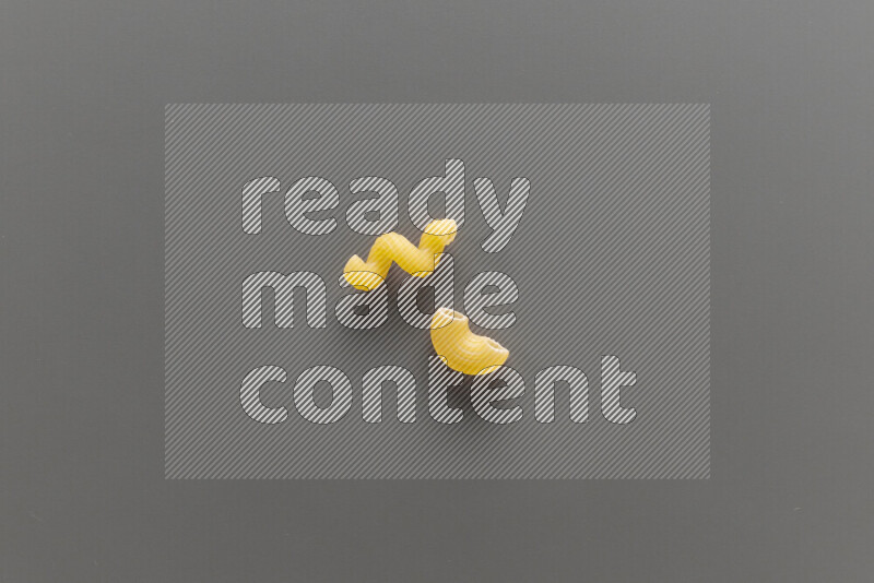 Twist pasta with other types of pasta on grey background