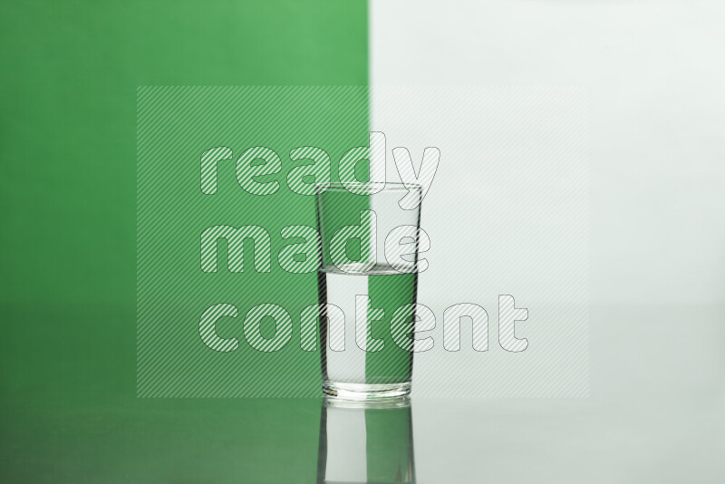 The image features a clear glassware filled with water, set against white and green background