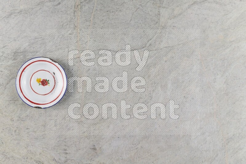 A vintage metal plate on grey marble background