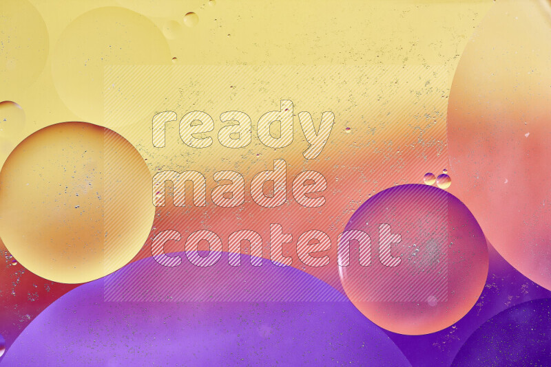 Close-ups of abstract oil bubbles on water surface in shades of yellow, orange and purple