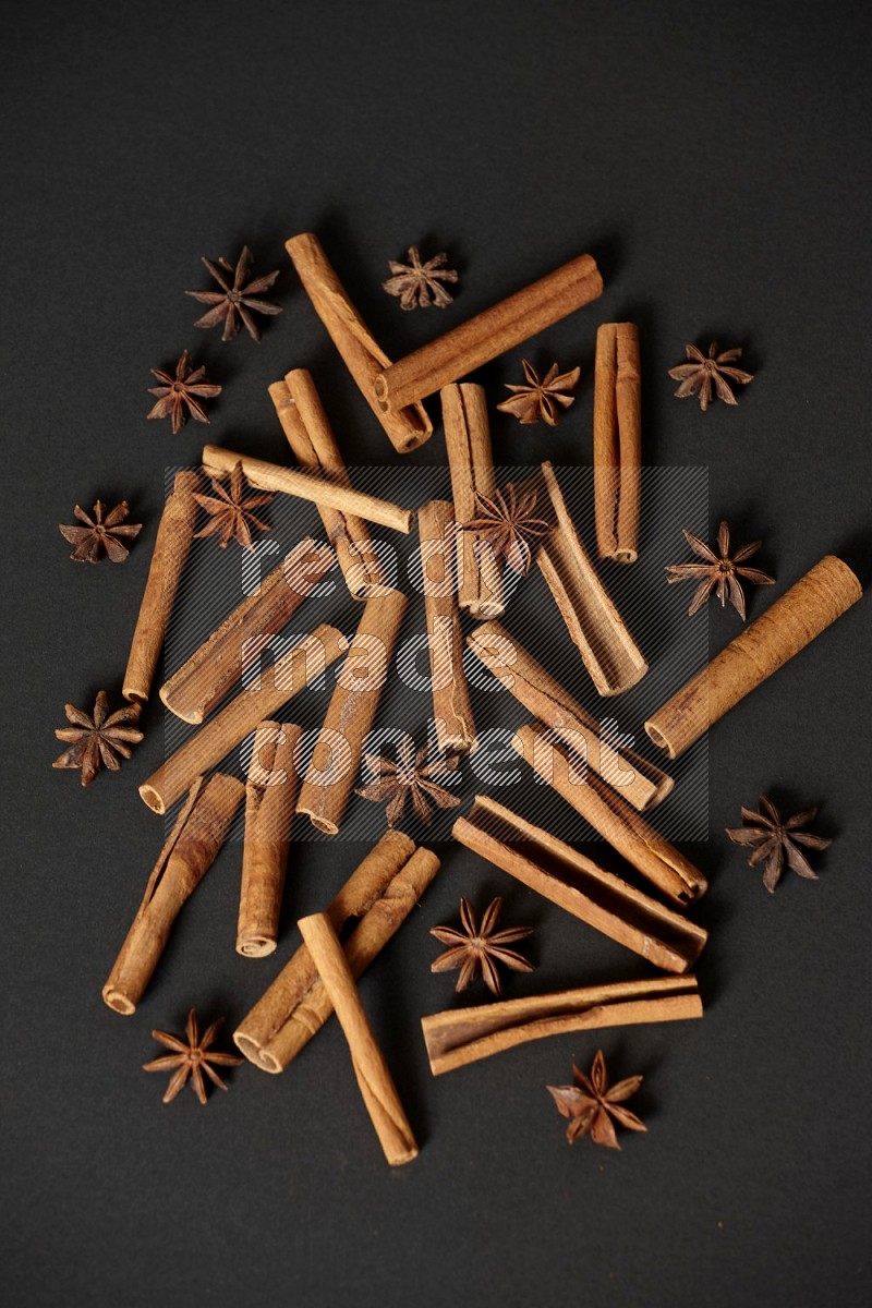 Cinnamon sticks and star anise on black background
