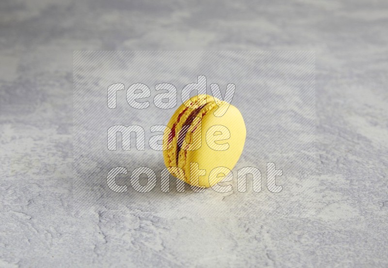 45º Shot of Yellow Lemon macaron on white  marble background