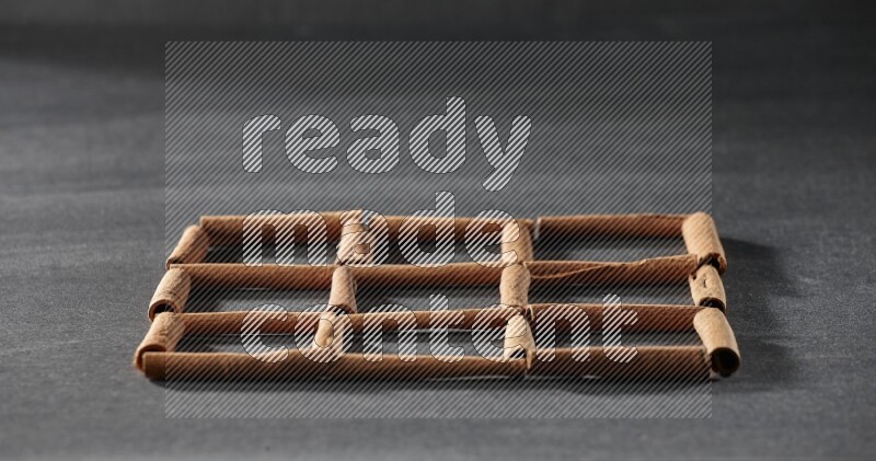 9 مربعات فارغة من أعواد القرفة على أرضية سوداء