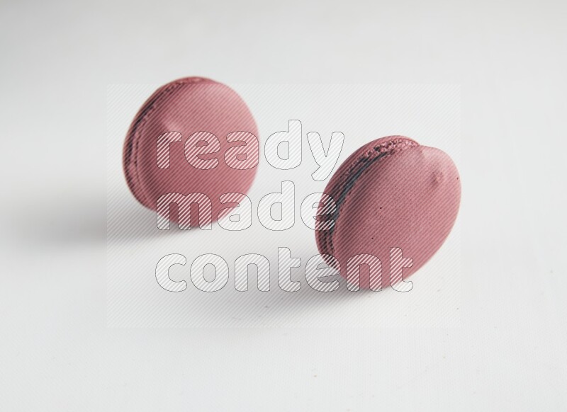 45º Shot of two Red Cherry macarons on white background