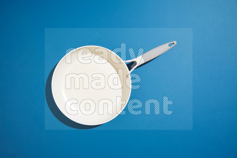 white pan on blue background