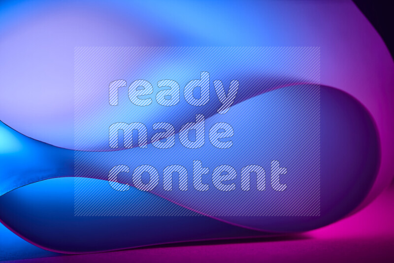 An abstract art piece displaying smooth curves in blue and pink gradients created by colored light