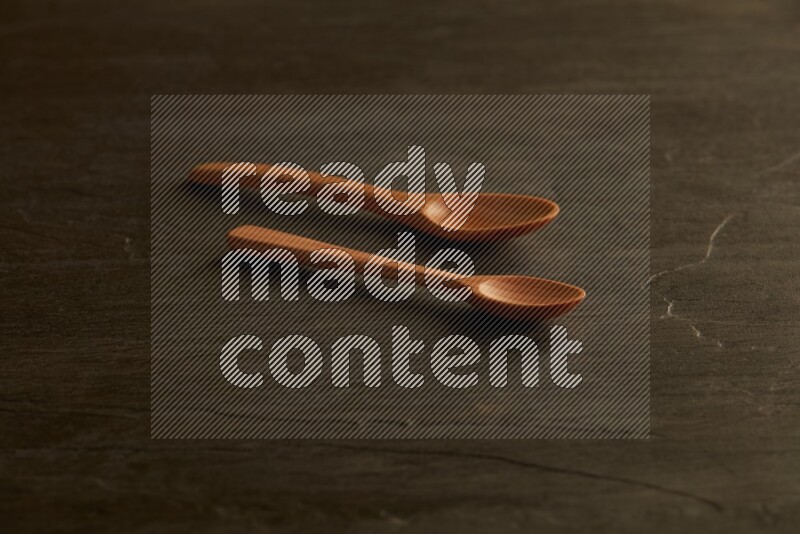 wooden spoon on black slate background