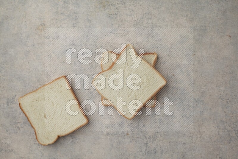White Toast slices on alight blue textured background
