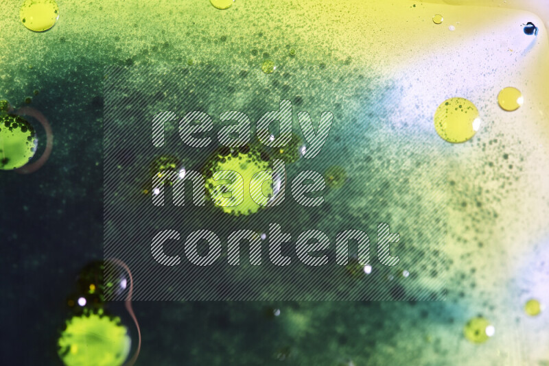 Close-ups of abstract green and yellow watercolor drops on oil Surface on white background