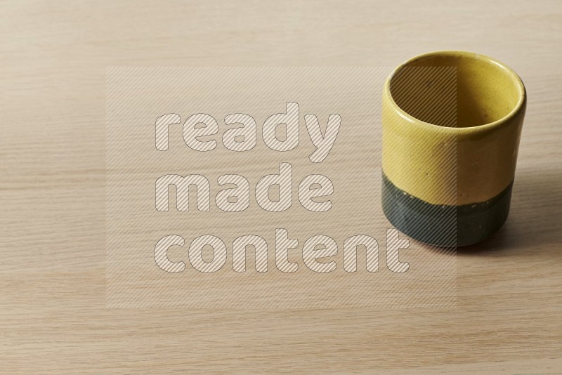 Multicolored Pottery Cup on Oak Wooden Flooring, 45 degrees
