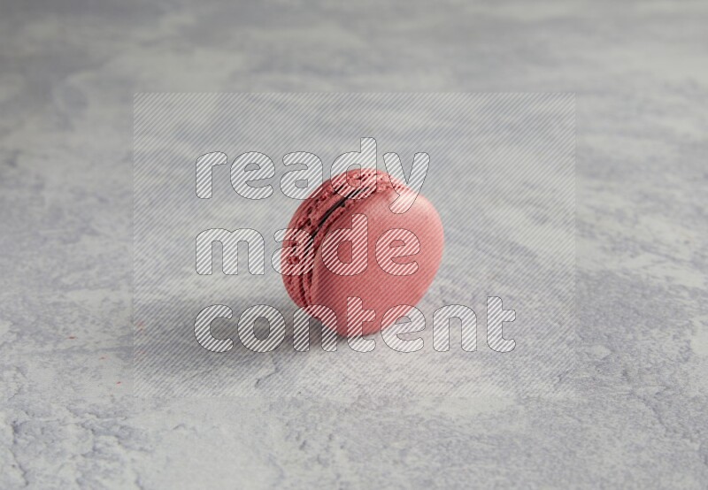 45º Shot of Pink Raspberry macaron on white  marble background