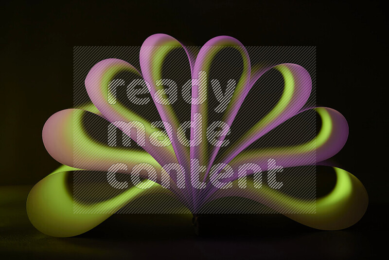 An abstract art piece displaying smooth curves in pink and green gradients created by colored light