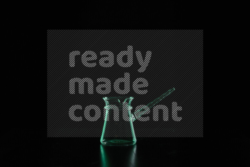 Glassware with rim light in green against black background