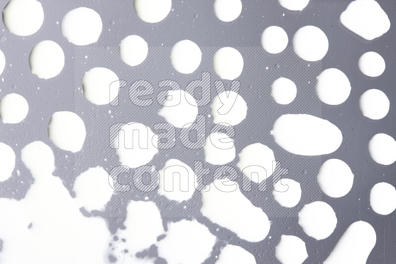 Close-ups of abstract white paint droplets on the surface