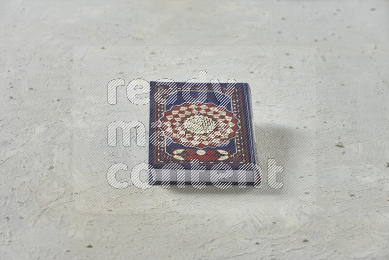 Quran with a prayer beads on white background