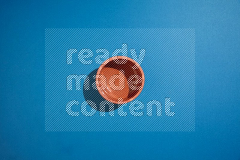 brown bowl on blue background